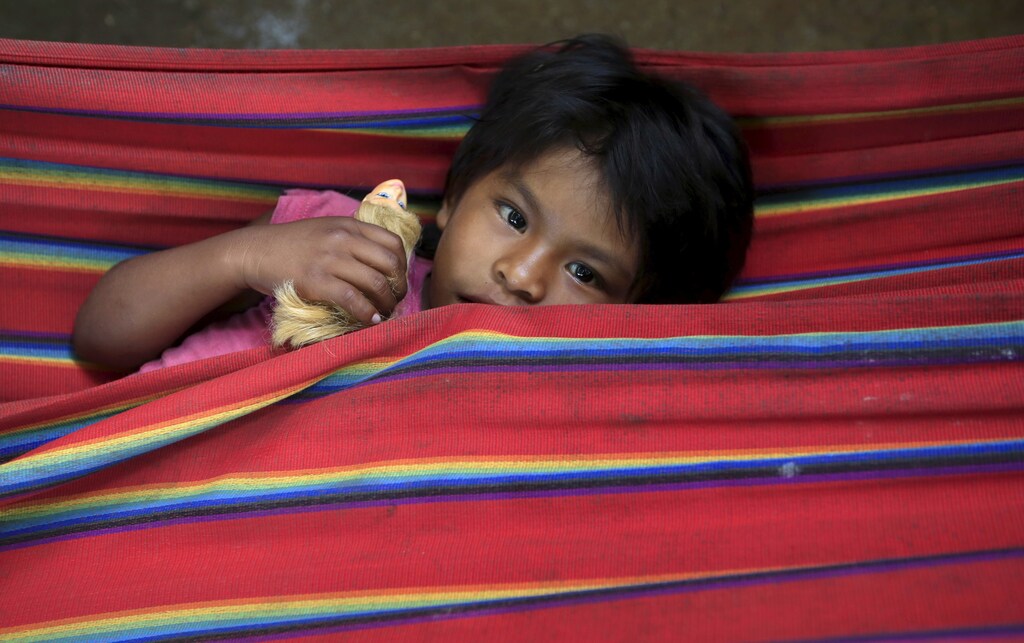 A Colombian Nukak Maku Indian child rests in a refugee camp at Agua Bonita near San Jose del Guaviare of Guaviare province September 3, 2015. Since emerging from the jungle in 2005, half naked and carrying blowpipes, the Nukak have lived in settlements near the frontier town of San Jose del Guaviare, a humid outpost in the Amazon 400 km (250 miles) southeast of the capital Bogota. Picture taken September 3, 2015. To match Feature HEALTH-MENTAL/COLOMBIA REUTERS/John Vizcaino TPX IMAGES OF THE DAY - RTS2EVZ