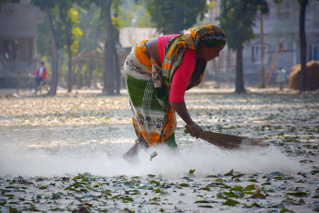a women sweeps the floor