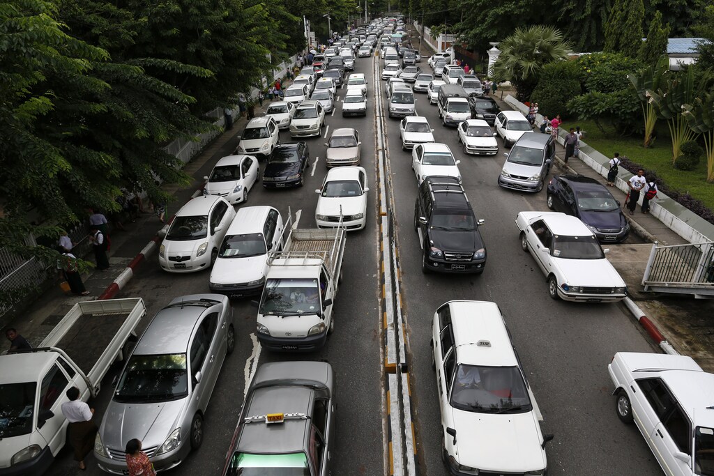Lines of cars are seen stuck in a traffic jam along Alanpya Pagoda road in Yangon, July 3, 2013. Toe Aung, a former army major, bears one of the biggest responsibilities in reform-era Myanmar: planning Yangon's unstoppable transformation from a regional backwater into Southeast Asia's next megacity. Picture taken July 3, 2013. To match Insight MYANMAR-YANGON/ REUTERS/Soe Zeya Tun (MYANMAR - Tags: BUSINESS TRANSPORT POLITICS SOCIETY) - RTX13GKD