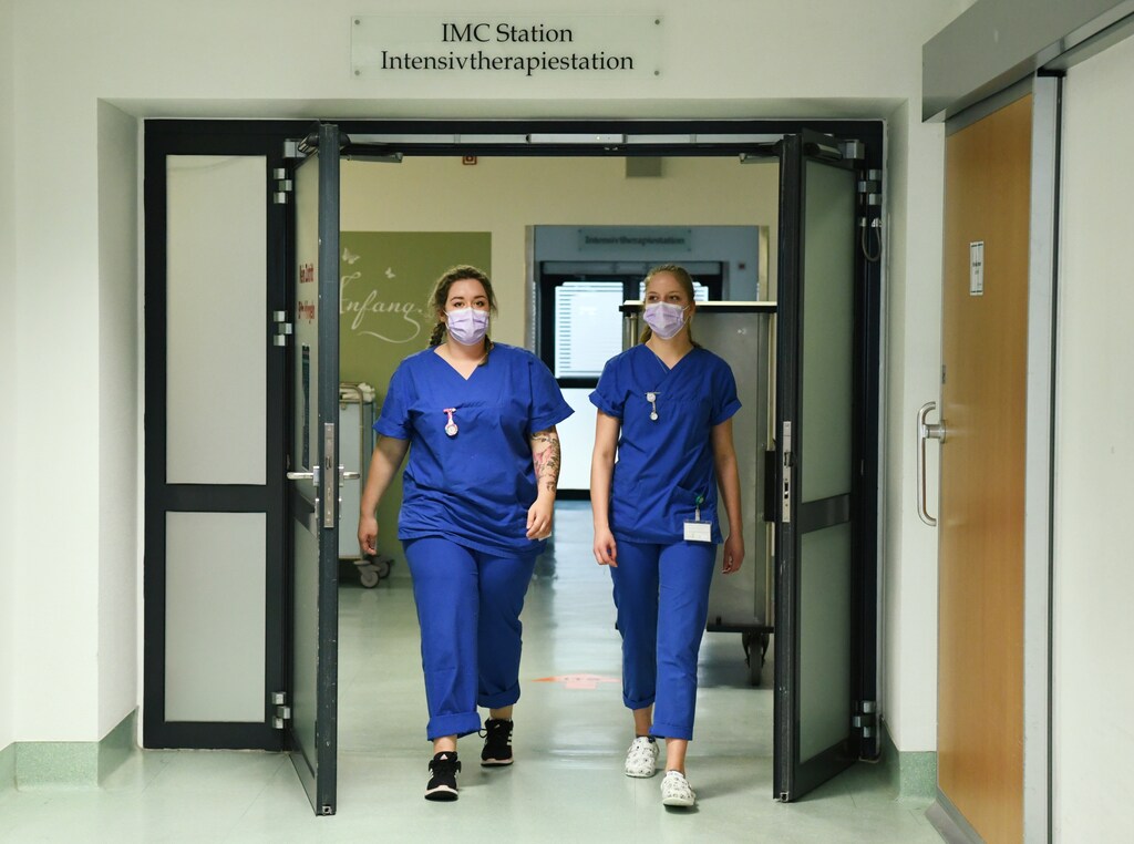 Trainee nurses Christin Schwibbe and Emma Stachelhaus leave the intensive care unit at the Asklepios clinic, as the spread of coronavirus disease (COVID-19) continues, in Pasewalk, Germany March 30, 2020. Picture taken March 30, 2020. REUTERS/Annegret Hilse - RC20VF9421MH