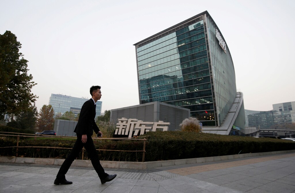 FILE PHOTO -- A man walks past New Oriental Education & Technology Group headquarters in Beijing, China, November 16, 2016. To match Special Report COLLEGE-CHINA/TESTING REUTERS/Jason Lee/File Photo - RTX2WBA2