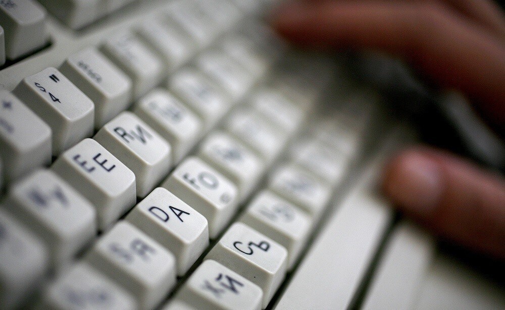 An employee types on a computer keyboard with both Latin and Cyrillic letters in Sofia June 23, 2008.