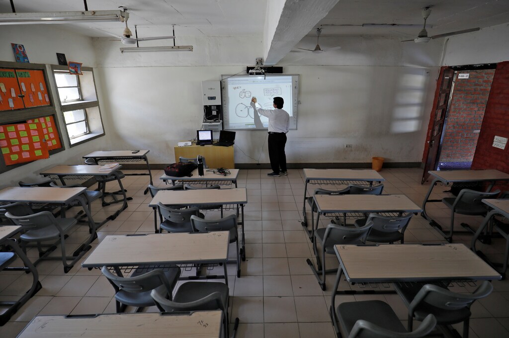 A teacher takes an online class for his students inside a private school after Gujarat government ordered the closure of schools and colleges across the state amid coronavirus fears, in Ahmedabad, India.