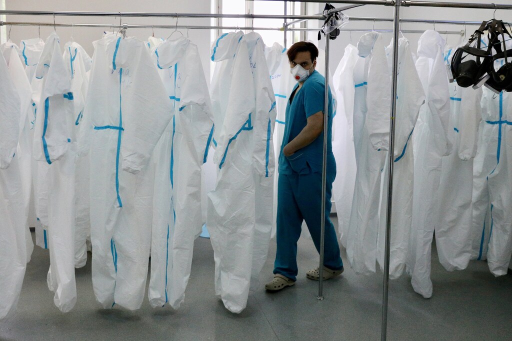 A medical specialist walks past personal protective equipment (PPE) in the hospital No. 1 named after N.I. Pirogov, which delivers treatment to patients infected with the coronavirus disease (COVID-19), in Moscow, Russia May 23, 2020. Kirill Zykov/Moscow News Agency/Handout via REUTERS ATTENTION EDITORS - THIS IMAGE HAS BEEN SUPPLIED BY A THIRD PARTY. MANDATORY CREDIT. TPX IMAGES OF THE DAY - RC2KUG9PZJ6R