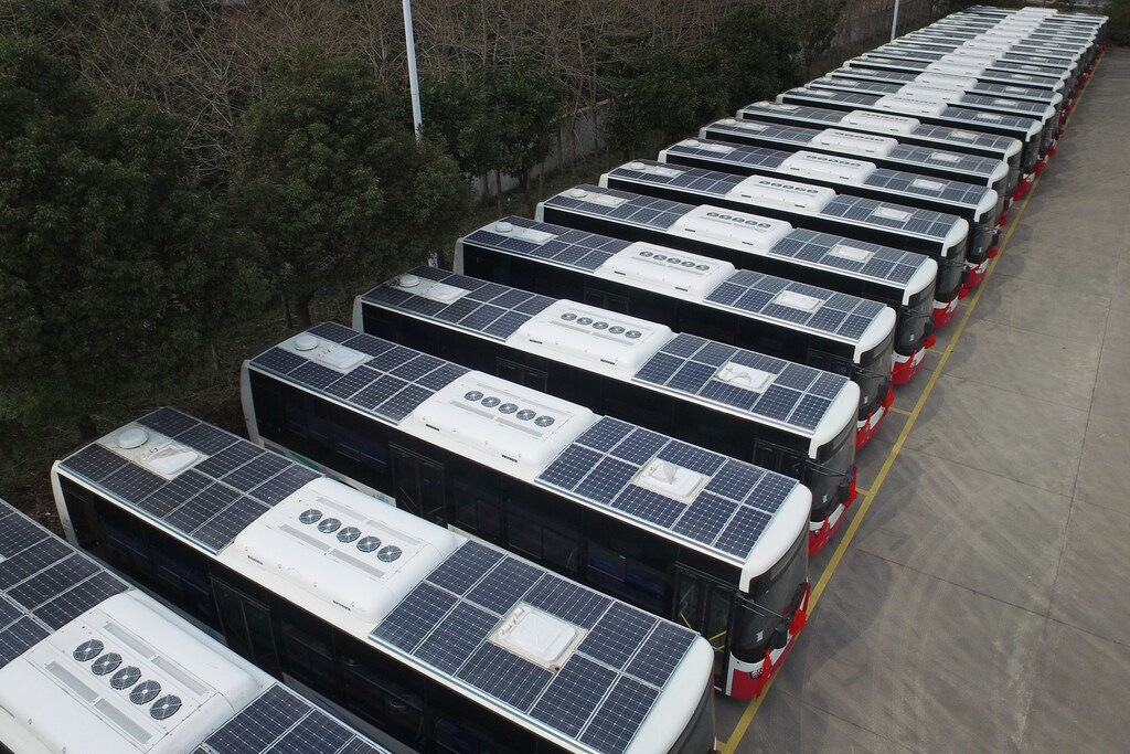 Buses with solar panels installed on their roofs to save electricity are seen in a parking lot in Hangzhou, Jiangsu Province, China, March 17, 2016.