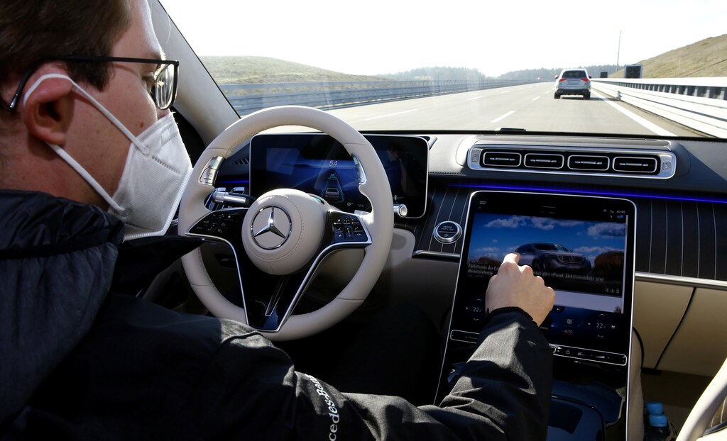 A person demonstrates the Drive Pilot Level 3 autonomous driving system