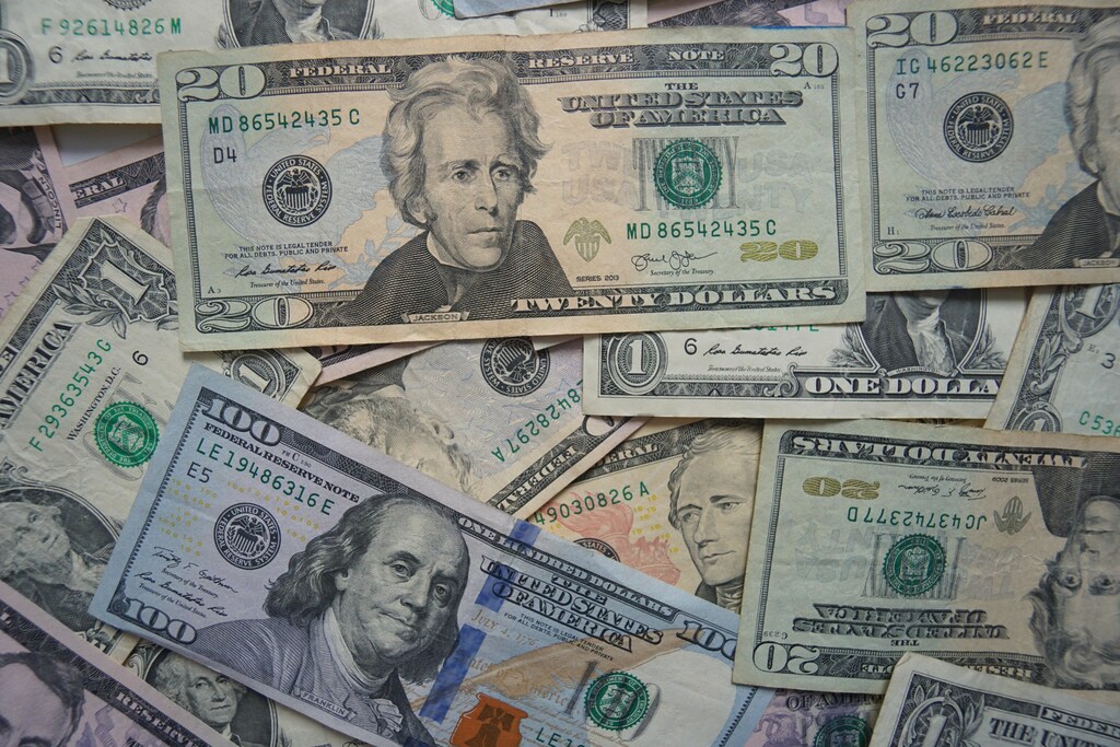 Dollar bills overlapping each other.