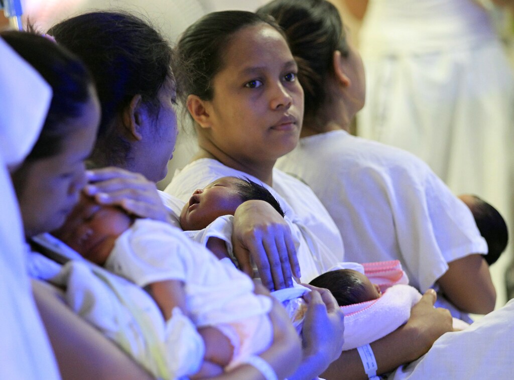International Women's Day: Mothers and their newborn babies wait for their checks-up inside the Fabella hospital, dubbed as the busiest maternity hospital in the country, in Manila, Philippines February 16, 2016. A minister in the Philippines has urged women to delay pregnancy until more is known about the mosquito-borne Zika virus raging in Latin America, even though the Asian country's only reported case of zika was four years ago. REUTERS/Romeo Ranoco