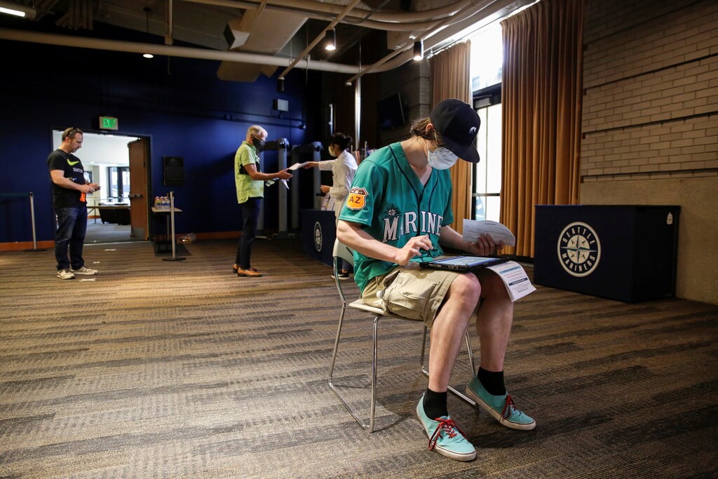 Craig McCall of Tacoma, Washington, who was furloughed from his job at the Emerald Queen Casino, fills out paperwork to donate blood during a Pop-Up Blood Drive experience at T-Mobile Park, the stadium of Major League Baseball's Seattle Mariners, as efforts continue to help slow the spread of the coronavirus disease (COVID-19) in Seattle, Washington, U.S. April 13, 2020.