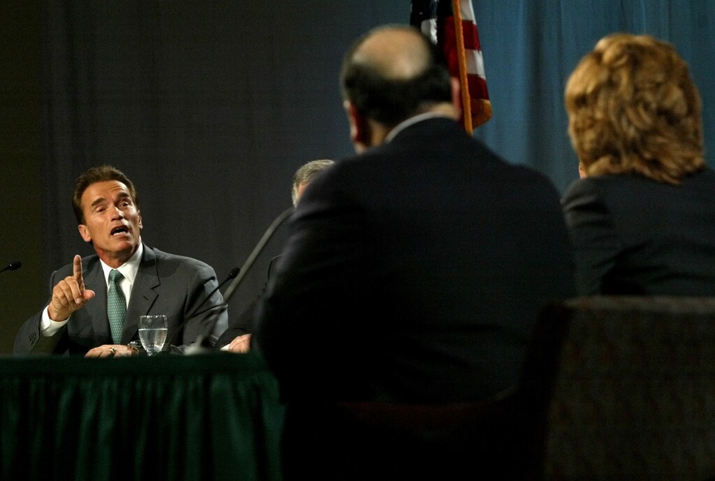 Actor Arnold Schwarzenegger makes a point to Lt. Gov. Cruz Bustamante(C) and independent Ariana Huffington during the gubernatorial debateat California State University in Sacramento, California September 24,2003. The recall election is set for October 7. REUTERS/KevorkDjansezian/POOLRG - RTR3KAD