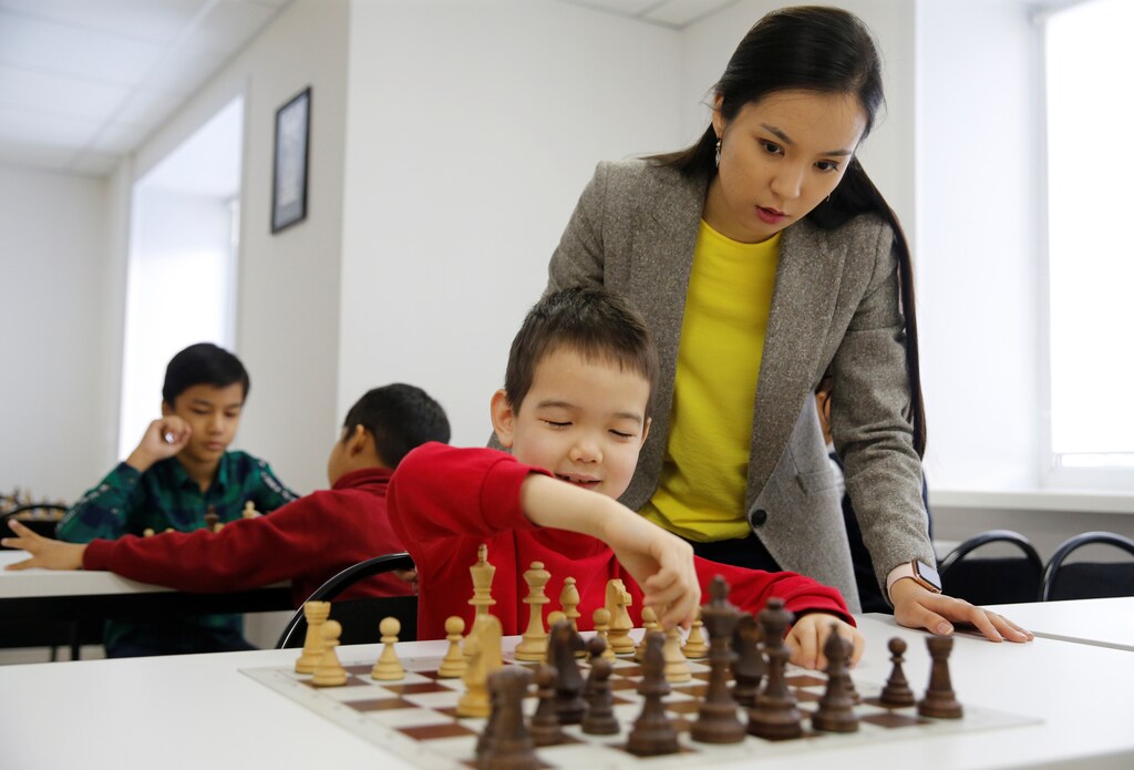 Dinara Saduakassova, a 23-year-old Kazakh chess player and social activist, teaches children in the Chess Academy she founded in Nur-Sultan, Kazakhstan March 3, 2020. Saduakassova has opened a chain of chess schools in the country and has become a Goodwill Ambassador of the UNICEF. Picture taken March 3, 2020. REUTERS/Pavel Mikheyev - RC2ODF99KN3U