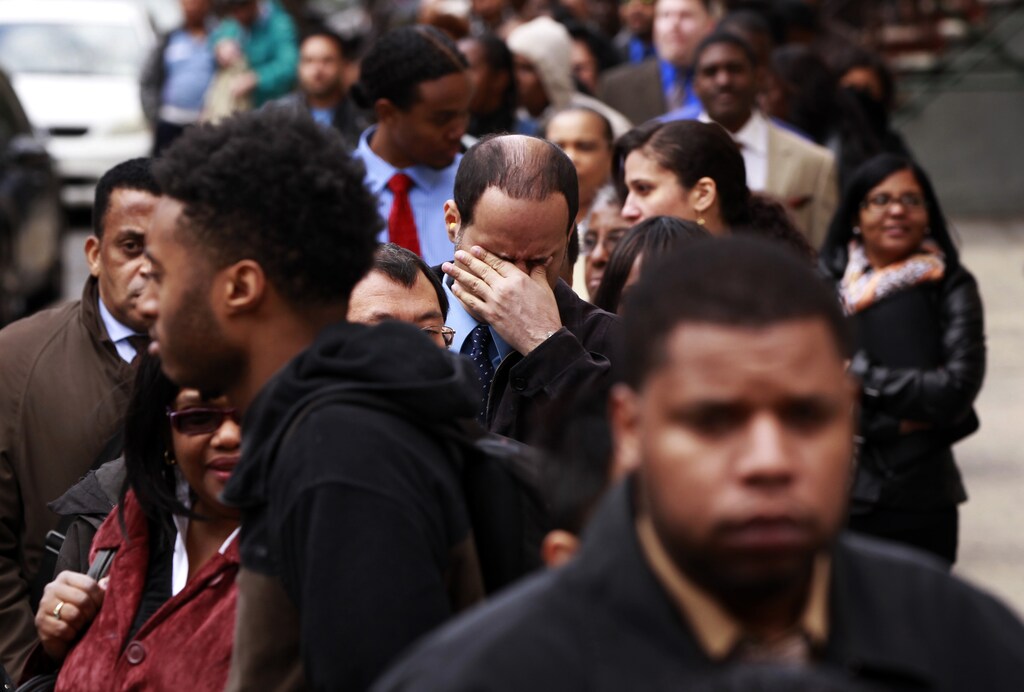 A man rubs his eyes as he waits in a line of jobseekers, to attend the Dr. Martin Luther King Jr. career fair held by the New York State department of Labor in New York April 12, 2012. A report on Friday showed the economy created only 120,000 jobs last month, the fewest since October. The unemployment rate fell to a three-year low of 8.2 percent, but largely as people gave up the search for work. REUTERS/Lucas Jackson (UNITED STATES - Tags: BUSINESS EMPLOYMENT) - GM1E84D0G4201