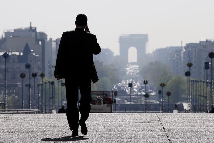 A businessman walks on the esplanade of La Defense, in the financial and business district in La Defense, west of Paris, April 10, 2014. REUTERS/Gonzalo Fuentes (FRANCE - Tags: BUSINESS)