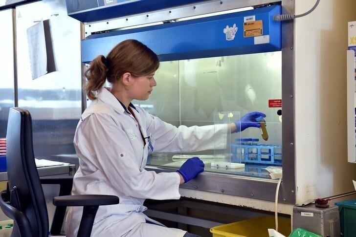 A scientist manipulates a vial that contains faeces in a laboratory at the University of Ghent, Belgium August 23, 2018. The donated faeces will be used to improve the bowel movements of sick patients. Picture taken August 23, 2018. REUTERS/Eric Vidal