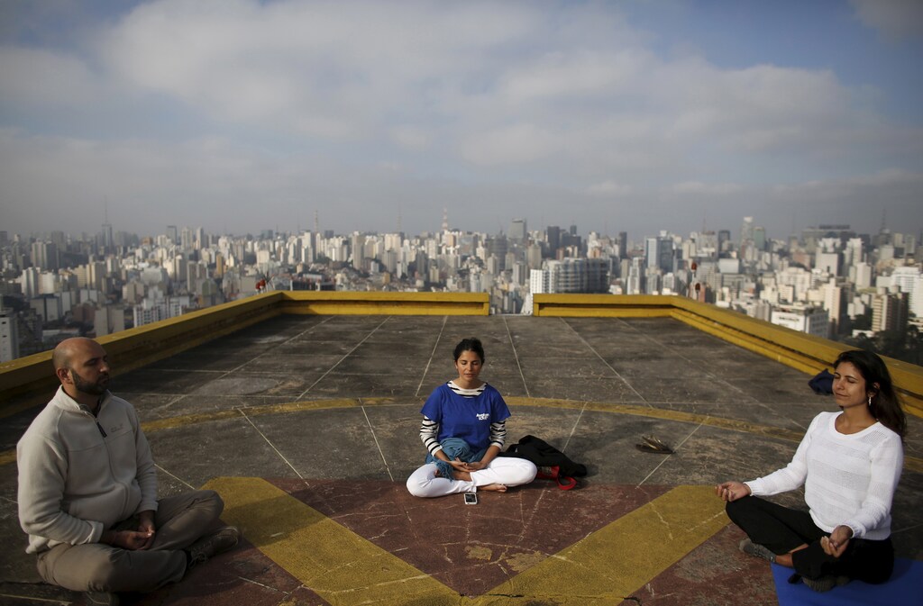 People meditate on the helipad of Copan building to celebrate World Health Day.