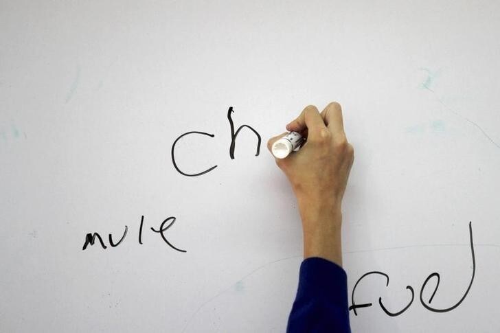 A primary school student writes on a whiteboard at a school in Cuernavaca April 4, 2011. Mexico is suffering from an out-of-date education system, dominated by political and trade union interests that hinder the ambitions of a country that could grow at higher rates. Picture taken April 4, 2011. REUTERS/Carlos Jasso (MEXICO - Tags: POLITICS EDUCATION)
