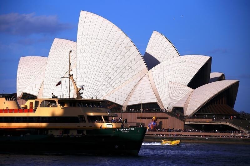 A ferry passes the Sydney Opera House where a large lantern shaped as a dog stands as part of celebrations for the Chinese Lunar New Year and marking the Year of the Dog in Sydney, Australia February 16, 2018. REUTERS/David Gray - RC15AFFA0CB0