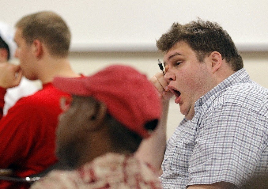 A student yawns during the "Fundamentals of Algebra" class, which is held from 11:45pm to 2:30am, at Bunker Hill Community College in Boston, Massachusetts September 8, 2010, one of five midnight classes offered this semester due to surging enrollment. Bunker Hill's experiment with "midnight oil" classes began with two classes a year ago and a handful of other colleges, from Maryland to Illinois to California, have followed Bunker Hill's lead and are offering midnight classes to cope with overflowing enrollment. Picture taken September 8, 2010. REUTERS/Brian Snyder (UNITED STATES - Tags: EDUCATION SOCIETY) - RTXSS3F
