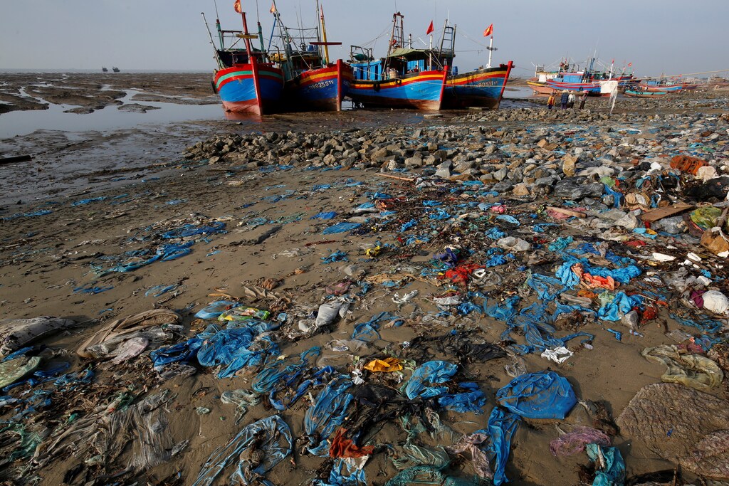 FILE PHOTO: Fisherman boats are seen in a beach with plastic waste at a the beach in Thanh Hoa province, Vietnam June 4, 2018. REUTERS/Kham/Files