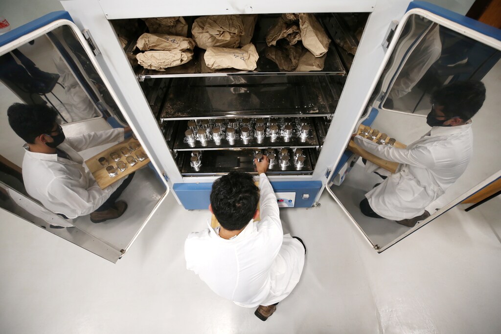 Brazilian forestry student Mateus Sanquetta separates material collected in the Amazon to check how much climate-warming greenhouse gas a small plot of the rainforest can contain, at the Center of Excellence in Research on Carbon Fixation in Biomass at the Federal University of Parana in Curitiba, Brazil, December 1, 2020. Picture taken Decemer 1, 2020 REUTERS/Rodolfo Buhrer - RC2O5L9AW3LH