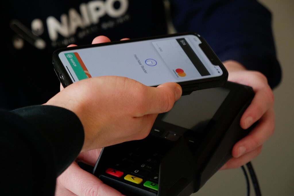 A person paying for service using card on phone.