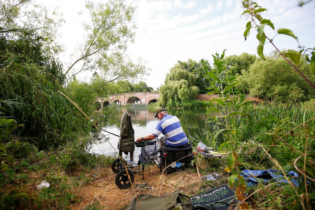 A man fishes on the River Thames in Sonning, Britain, a village where British Prime Minister Theresa May has a home, July 8, 2018. Picture taken July 8, 2018. To match Special Report BRITAIN-EU/MAY REUTERS/Henry Nicholls - RC16BF2AF830