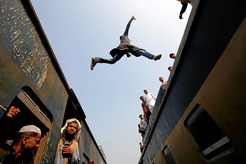 A commuter jumps between trains upon arrival at a station, to attend Akheri Munajat, the final supplication during Biswa Ijtema in Tongi, on the outskirts of Dhaka January 15, 2017. REUTERS/Mohammad Ponir Hossain TPX IMAGES OF THE DAY - RC1D6738EC20