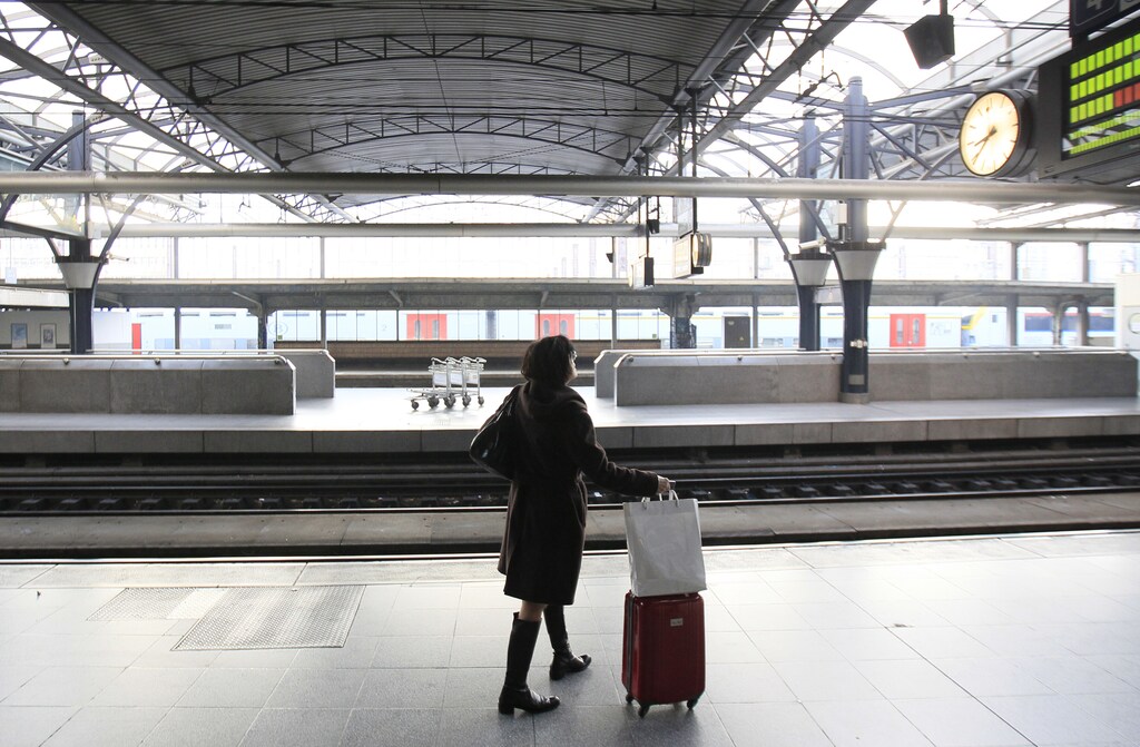 A passenger waits on an empty platform at the Thalys high-speed train terminal at Brussels Midi/Zuid rail station during an European strike November 14, 2012. Millions of workers joined strikes across southern Europe on Wednesday to protest against spending cuts and tax hikes that trade unions say have brought misery and deepened the region's economic crisis. REUTERS/Yves Herman (BELGIUM - Tags: POLITICS CIVIL UNREST BUSINESS EMPLOYMENT TRANSPORT)