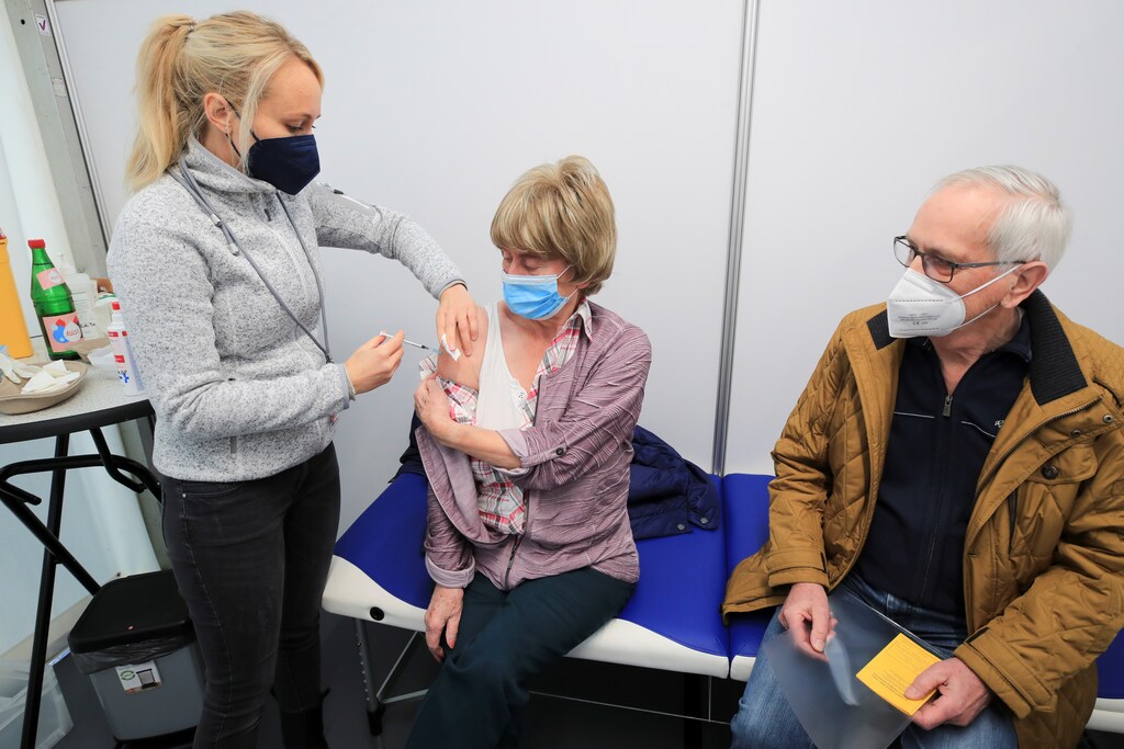 A woman is vaccinated against the coronavirus disease (COVID-19) at drive-in vaccination centre at Lanxess Arena in Cologne, Germany, November 23, 2021. REUTERS/Wolfgang Rattay