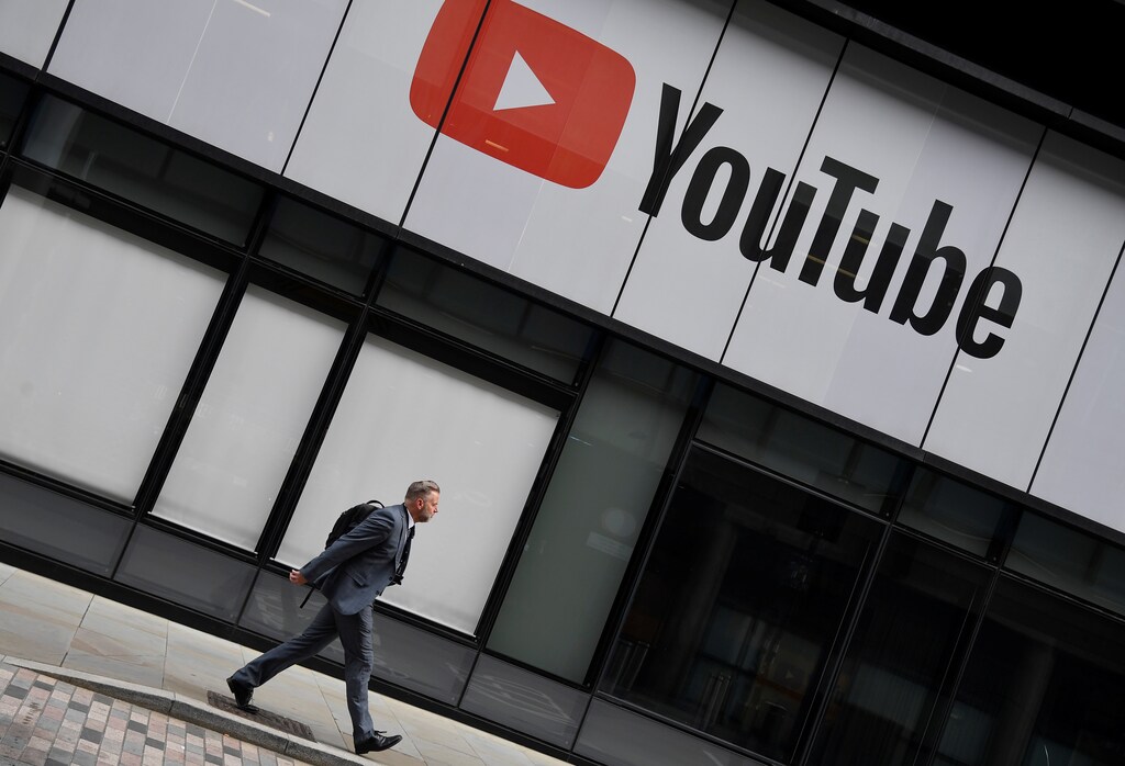 A worker walks past YouTube offices, in King's Cross, London, Britain, September 11, 2020. REUTERS/Toby Melville - RC2CWI99MPBH