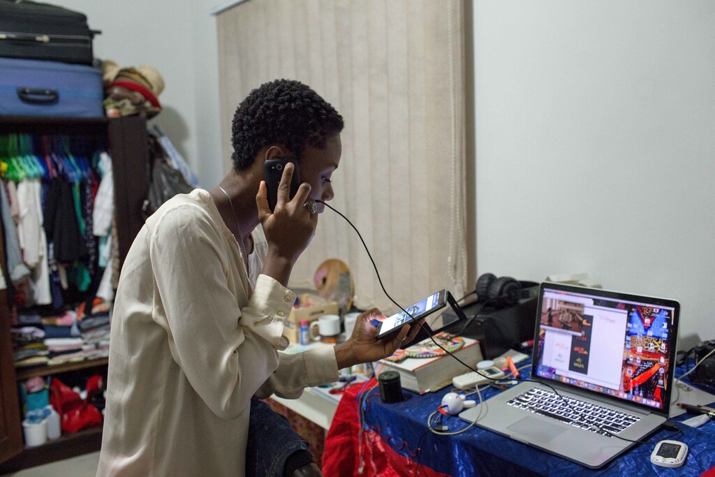 Illustrator Sena Ahadji speaks to a client on the phone from her house in Accra, Ghana, July 24, 2015.