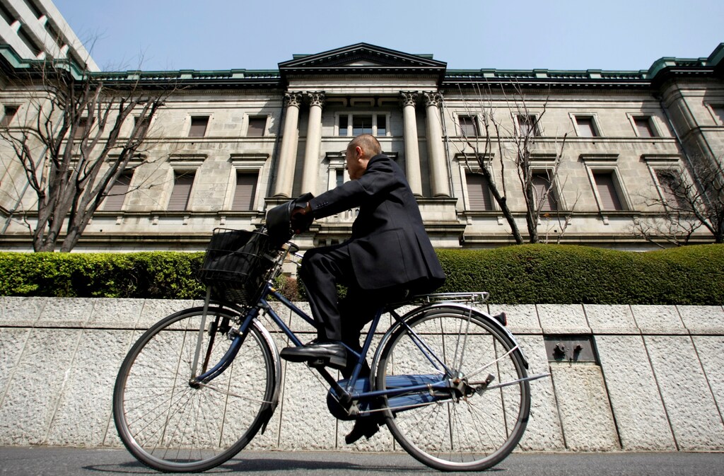 A man rides a bicycle past the Bank of Japan (BOJ) building in Tokyo, Japan March 18, 2009. REUTERS/Yuriko Nakao/File Photo - RTX2P8PI