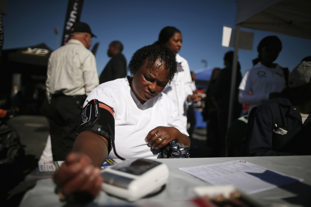 Bernita Jackson, 51, has her blood pressure measured at an event to inform people about the Affordable Care Act and donate turkeys to 5,000 needy families, in Los Angeles, California, November 25, 2013.