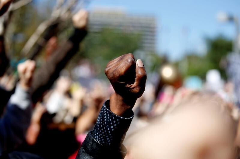People raise their fists into the air while participating in the second annual Women's March in Los Angeles, California, U.S. January 20, 2018.