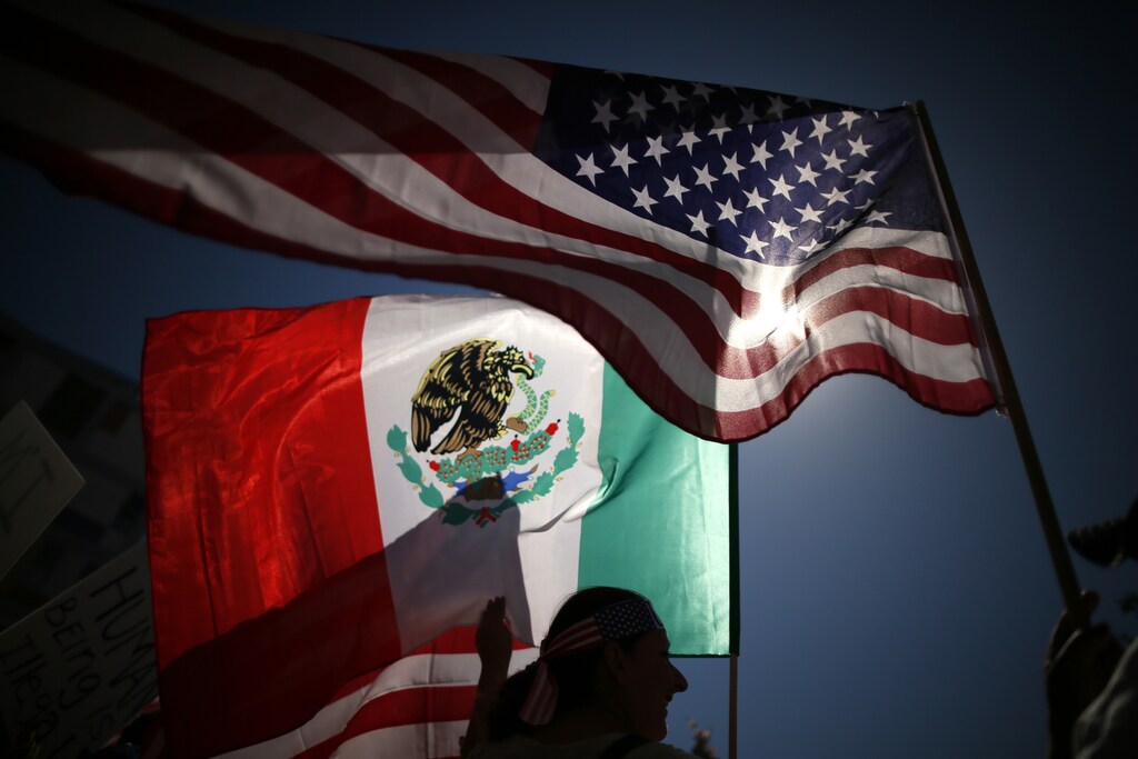 Protesters carry American and Mexican flags on their march to demand immigration reform in Hollywood, Los Angeles, California, October 5, 2013. REUTERS/Lucy Nicholson (UNITED STATES - Tags: POLITICS CIVIL UNREST SOCIETY IMMIGRATION) - RTR3FMWR