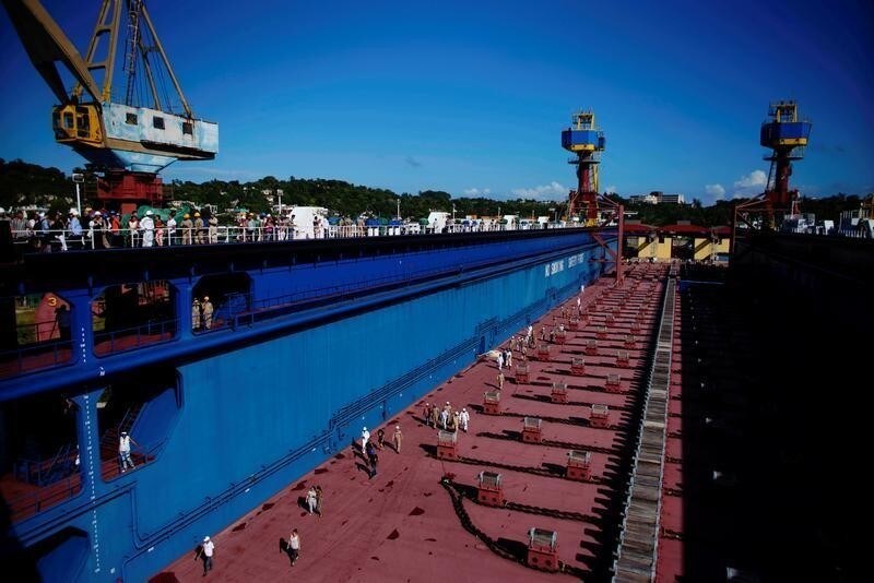 Docks' workers walk inside a newly acquired floating dock produced in China to repair Panamax-type ships in Havana, Cuba, October 30, 2019. REUTERS/Alexandre Meneghini - RC1EA41DBED0