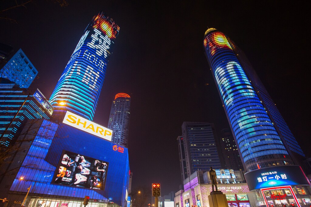 Shopping malls are seen before Earth Hour in Nanjing, Jiangsu province, China, March 25, 2017. Picture taken March 25, 2017. REUTERS/Stringer ATTENTION EDITORS - THIS IMAGE WAS PROVIDED BY A THIRD PARTY. EDITORIAL USE ONLY. CHINA OUT. NO COMMERCIAL OR EDITORIAL SALES IN CHINA. - RC1C706E1020
