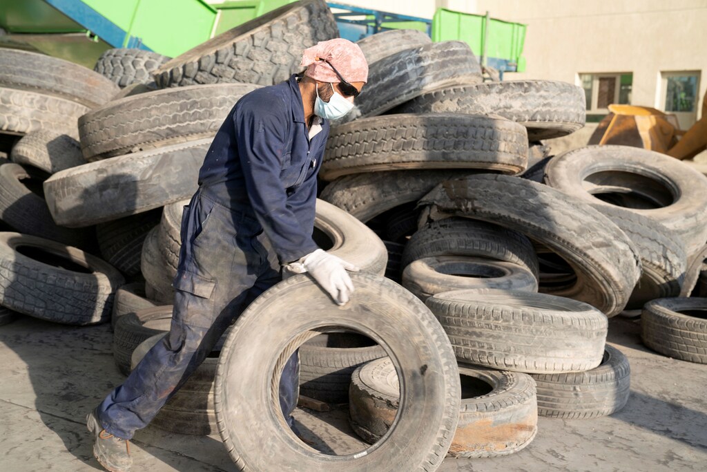 Circular economy - A worker is pictured at the EPSCO Global General Trading as he prepares to recycle a tyre at tyres recycling factory in al-Salmi area, Kuwait September 1, 2021.