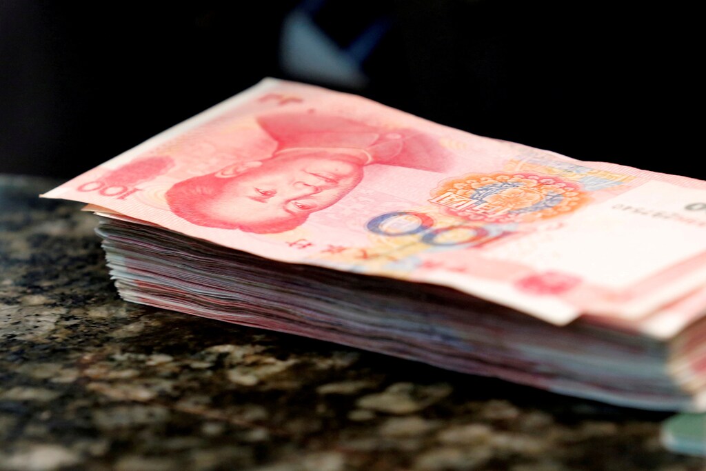 Chinese 100 yuan banknotes are seen on a counter of a branch of a commercial bank in Beijing, China, March 30, 2016. REUTERS/Kim Kyung-Hoon/File Photo - RTX2MIJE