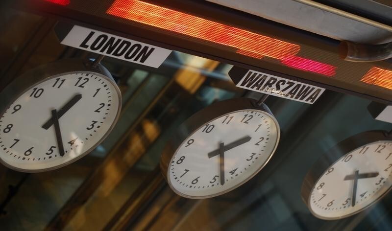 Clocks showing the time in different cities of the world are pictured in the Warsaw Stock Exchange January 22, 2013. REUTERS/Peter Andrews (POLAND - Tags: BUSINESS) - RTR3CSRE
