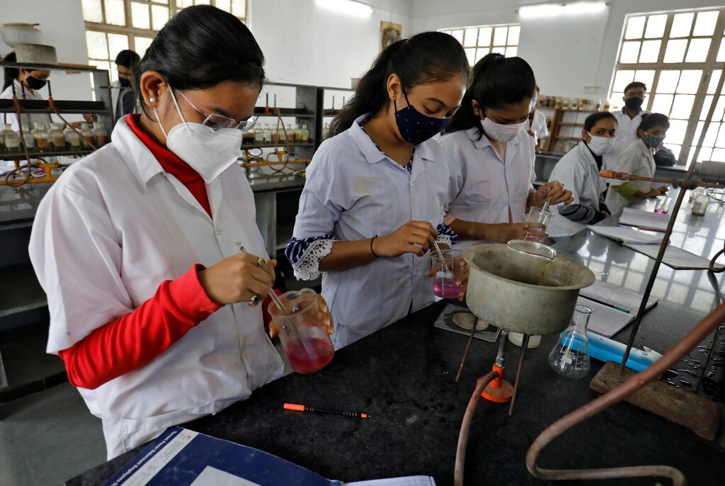 Students wearing protective face masks attend a laboratory class inside the M.G. Science Institute after authorities reopened all the colleges that were closed for months due to the coronavirus disease (COVID-19) outbreak, in Ahmedabad, India, February 8, 2021. REUTERS/Amit Dave - RC2BOL9HL71R