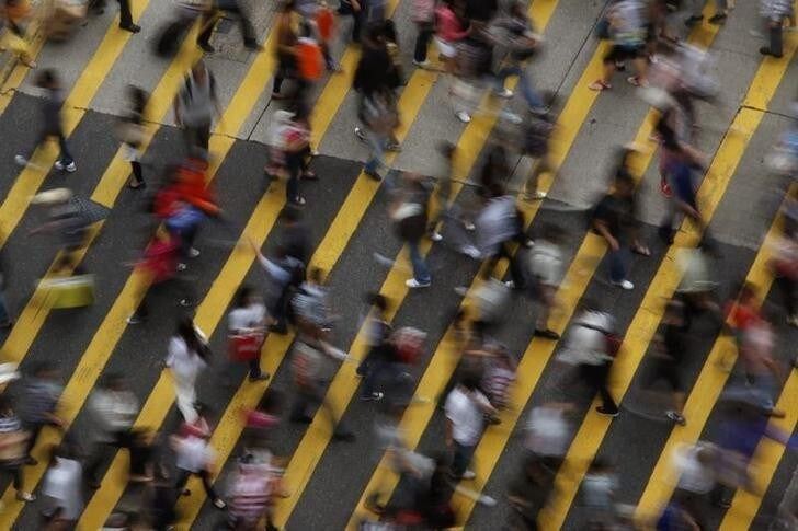 ATTENTION EDITORS - IMAGE 1 OF 22 OF PICTURE PACKAGE '7 BILLION, 7 STORIES - OVERCROWDED IN HONG KONG. SEARCH 'MONG KOK' FOR ALL IMAGES - People cross a street in Mong Kok district in Hong Kong, October 4, 2011. Mong Kok has the highest population density in the world, with 130,000 in one square kilometre. The world's population will reach seven billion on 31 October 2011, according to projections by the United Nations, which says this global milestone presents both an opportunity and a challenge for the planet. While more people are living longer and healthier lives, says the U.N., gaps between rich and poor are widening and more people than ever are vulnerable to food insecurity and water shortages. Picture taken October 4, 2011. REUTERS/Bobby Yip (CHINA - Tags: SOCIETY)