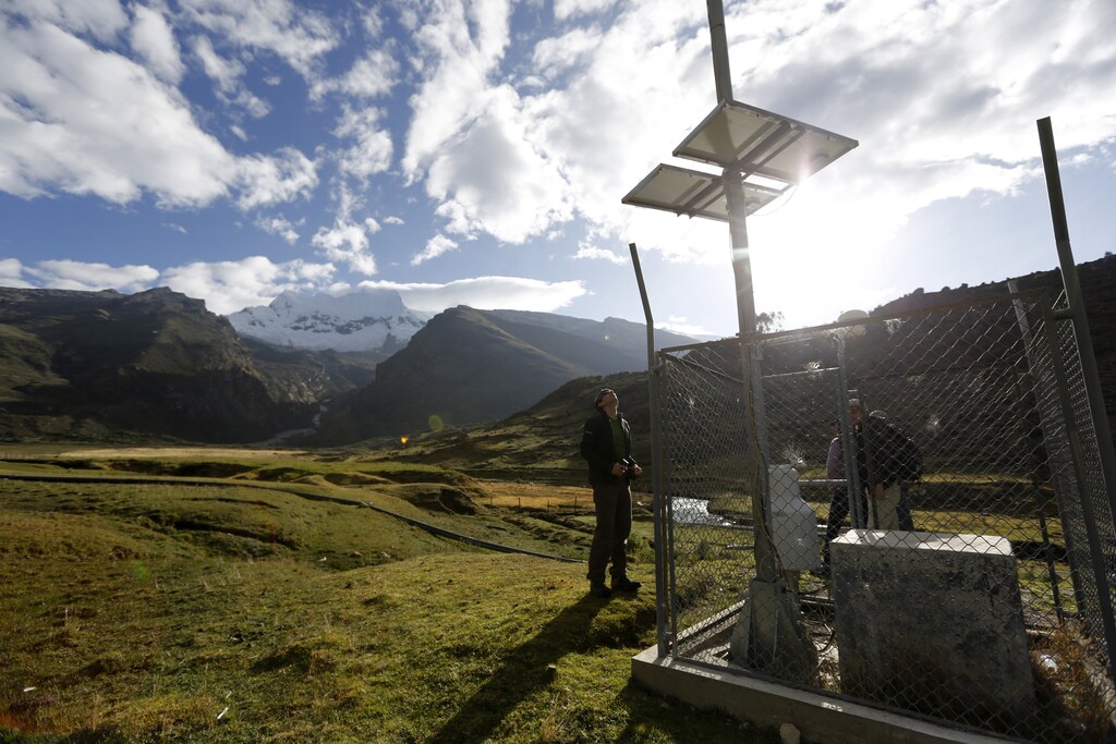 Glaciologist Christian Huggel checks the monitoring station he helped develop at Huascaran natural reserve in Ancash November 29, 2014. Peru has more tropical glaciers than any other nation but rising temperatures linked to global warming have helped shrink the ice masses by up to 40 percent, filling existing lakes to the brim and spawning hundreds of new ones. World greenhouse gas emissions are rising fast and it may be years before they start falling, prompting glaciologists to urge Peru to act fast to protect towns and villages in danger. In Lima, nearly 200 governments are meeting this week to thrash out a rough draft of a deal to cut carbon emissions in a bid to ward off more warming. The deal is due to be agreed in Paris in late 2015. Picture taken November 29. To match story CLIMATECHANGE-LIMA/GLACIERS REUTERS/ Mariana Bazo (PERU - Tags: ENVIRONMENT SCIENCE TECHNOLOGY) - GM1EACC03R101