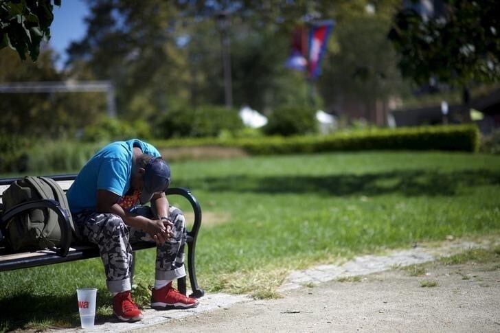 A homeless man sleeps on a park bench in Logan Square on the Benjamin Franklin Parkway in Philadelphia, Pennsylvania, September 23, 2015. Benjamin Franklin Parkway, a stretch of cultural centers and grassy parks where homeless sleep and tote their belongings in plastic bags, is undergoing papal security checks and cleanup that will displace some of the downtrodden that Francis champions. Philadelphia, a city of 1.5 million people, counts about 5,500 people living on the streets or other unsheltered areas, but that number does not include those in some of the city's poorest areas, homeless services group Project HOME said. The parkway, which will host two events attended by Francis, has been designated a top U.S. Secret Service security zone for the visit. Picture taken September 23, 2015. REUTERS/Mark Makela