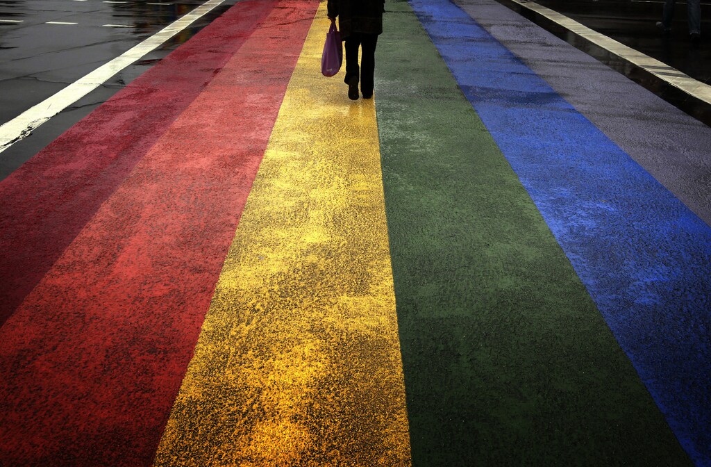 A pedestrian walks across a rainbow pedestrian crossing painted on Sydney's Oxford street, the city's main gay district April 4, 2013. Officials have ordered the removal of the rainbow pedestrian crossing painted on a street in Sydney's main gay district, setting off fierce debate in a city known for its annual Mardi Gras gay pride event, one of Australia's main tourist draws. Controversy over the crossing, painted in February to celebrate the 35th anniversary of the annual gay festival, is pitting those proud of Sydney's reputation for tolerance, such as gay former tennis star Martina Navratilova, against government officials who say it is a safety hazard. Picture taken April 4, 2013. REUTERS/David Gray (AUSTRALIA - Tags: SOCIETY TPX IMAGES OF THE DAY) - GM1E9450XVK01