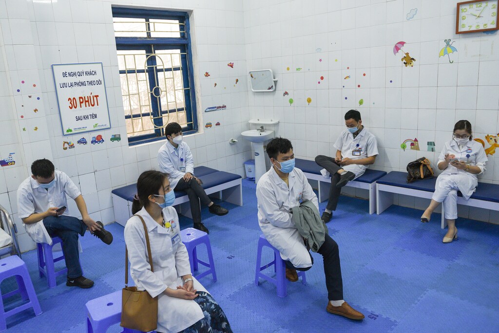 Health workers wait for their turn as Vietnam starts its official rollout of AstraZeneca's coronavirus disease (COVID-19) vaccine for health workers, at Hai Duong Hospital for Tropical Diseases, Hai Duong province, Vietnam, March 8, 2021. REUTERS/Thanh Hue - RC2U6M911IBY