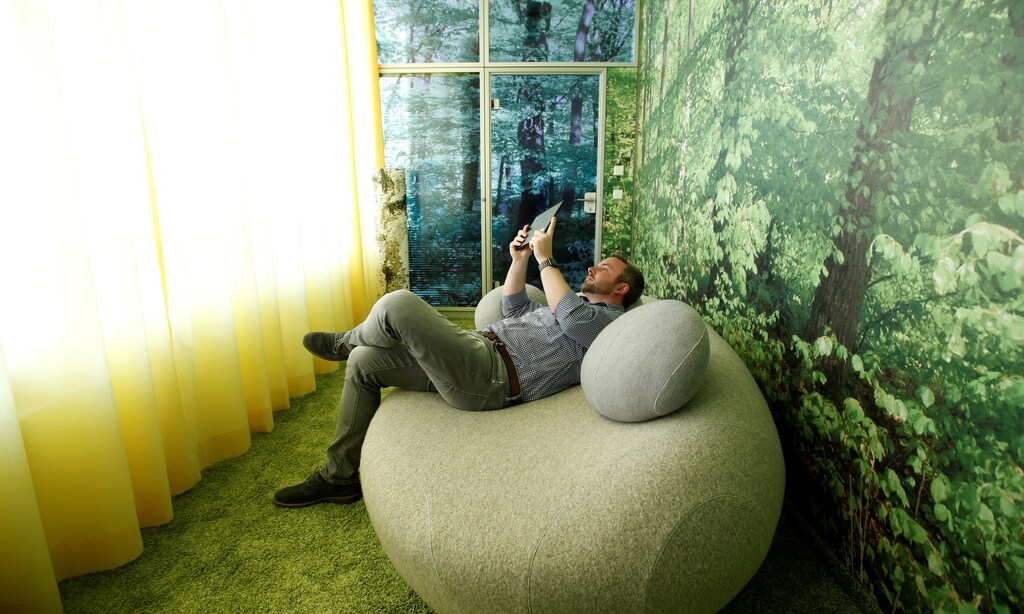 An employee tests a newly designed workplace in Stuttgart-Feuerbach, Germany