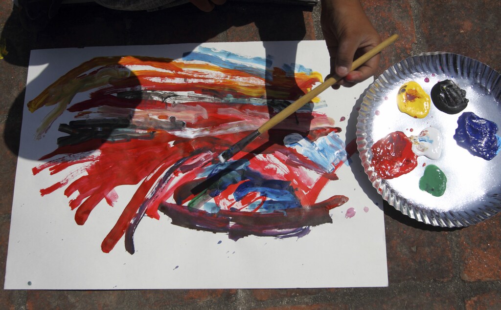 The shadow of a child is seen while he paints during a painting competition organized to mark World Down's Syndrome Day in Kathmandu March 21, 2011. Down's Syndrome is the most common genetic cause of mental retardation, occurring in 1 out of 700 live births worldwide. Down's occurs when a child has three copies of chromosome 21 instead of the normal two. REUTERS/Navesh Chitrakar (NEPAL - Tags: HEALTH SOCIETY) - GM1E73L1IJD01
