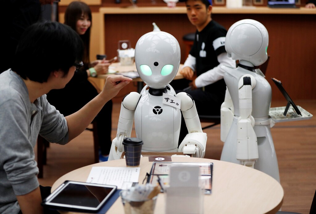 Remotely controlled robots OriHime-D, developed by Ory Lab Inc. to promote employment of disabled people, serve customers at a cafe in Tokyo, Japan November 26, 2018. REUTERS/Issei Kato - RC142F1E7620