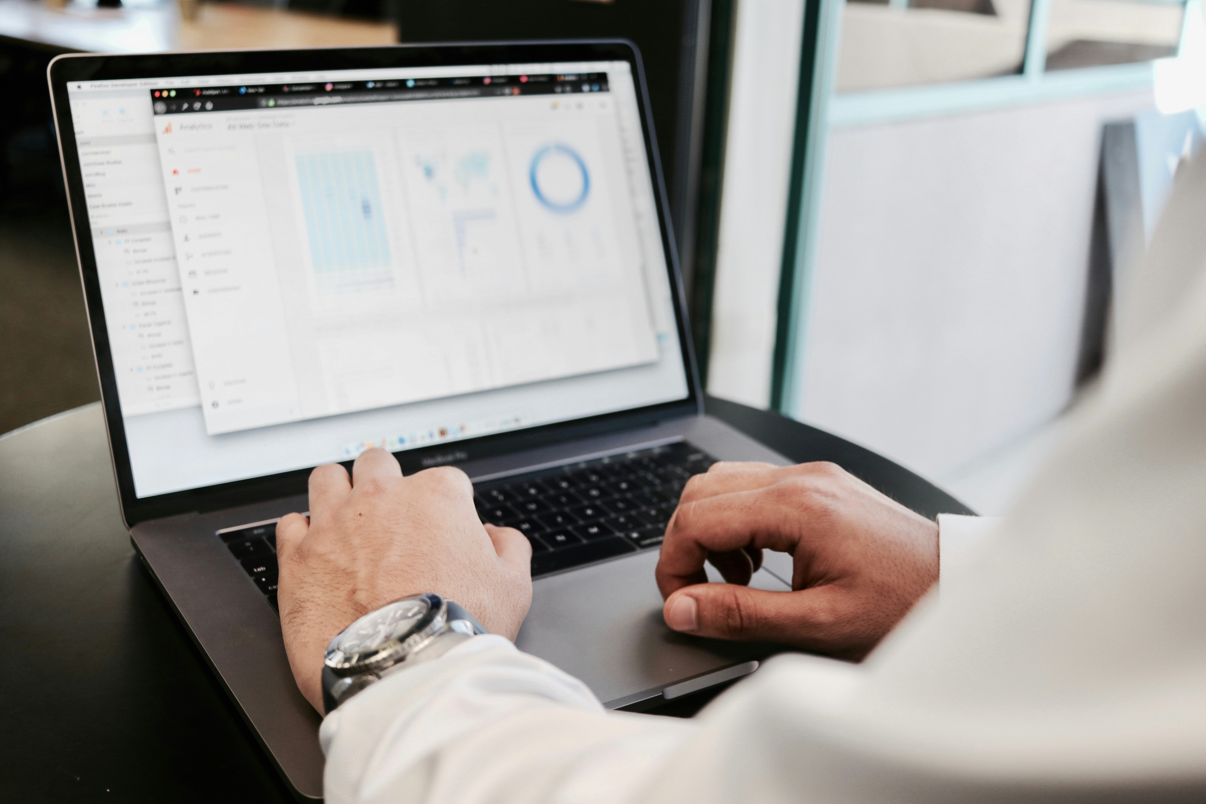 Person analyzing data on a laptop.